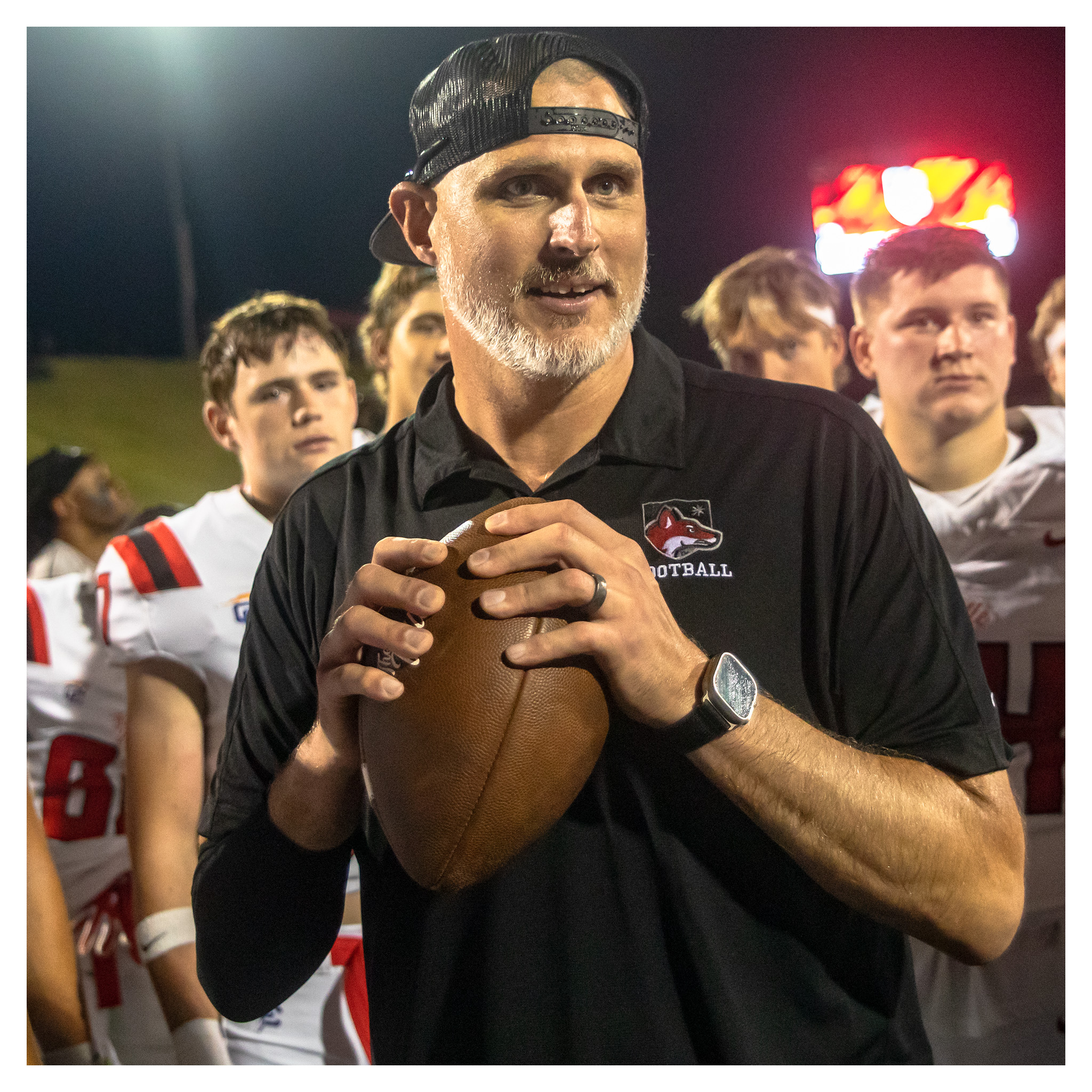 Nate Garner holding a football after a game